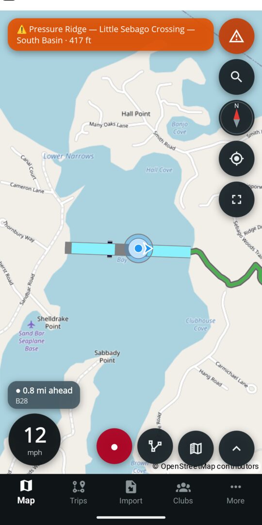 The map while riding, with an approach chip reading the distance to a Closed stretch ahead and the up-next line beneath it